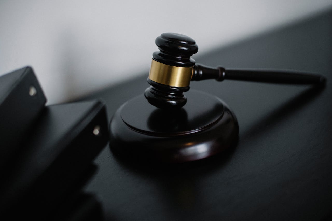 Offerings Close-up of a wooden gavel on a desk, symbolizing justice and legal authority.